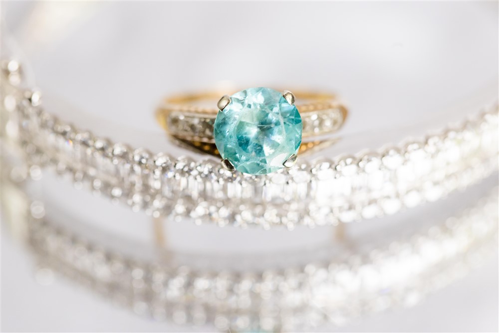 gold and green emerald wedding ring detail shot. Photo by Vanessa Joy Photography.