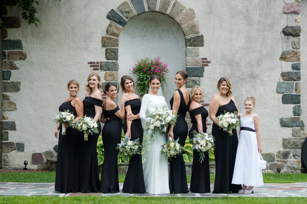 bride with bridesmaids wearing black dresses. Photo by Vanessa Joy photography