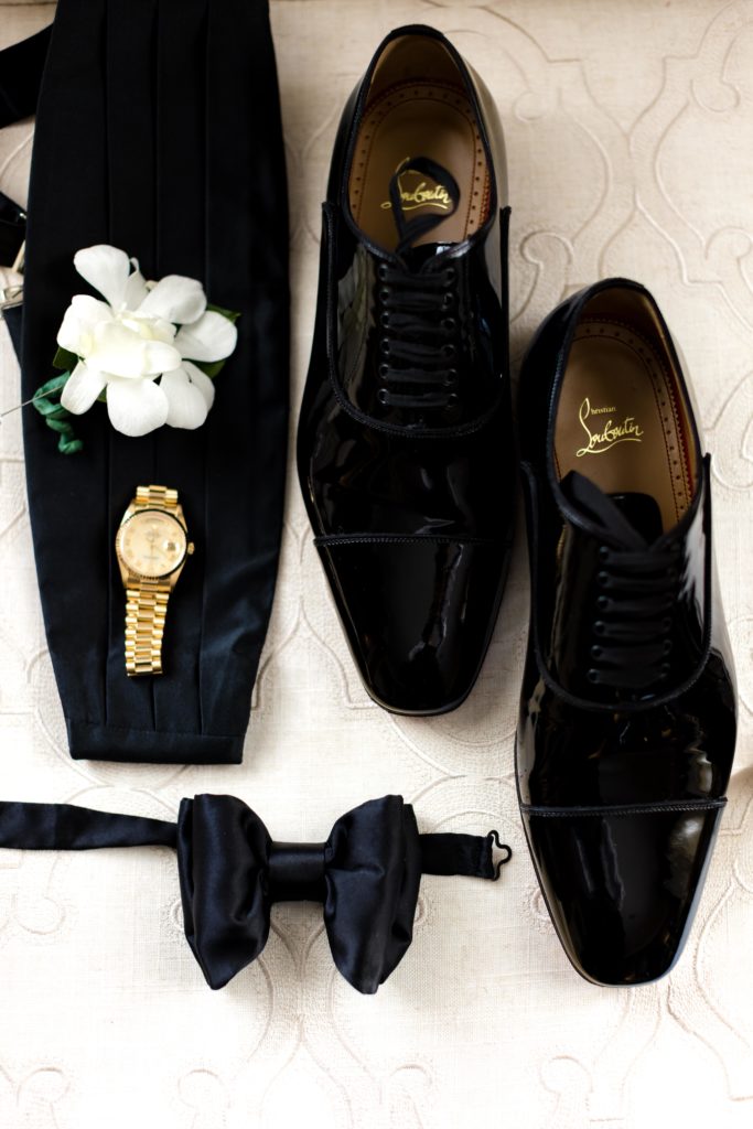 Christian Louboutin shoes, Rolex gold watch, black bowtie