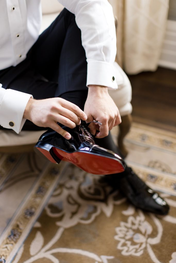 Christian Louboutin shoes detail, groom puts on his shoes