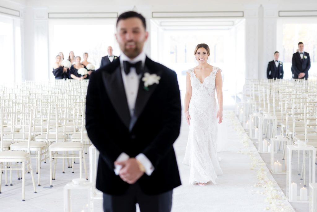 bride walks towards groom for first look