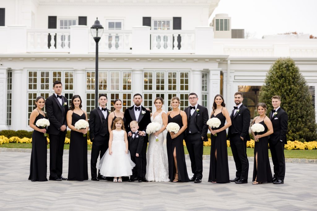 the entire wedding entourage in front of the mansion in in the Shadowbrook At Shrewsbury