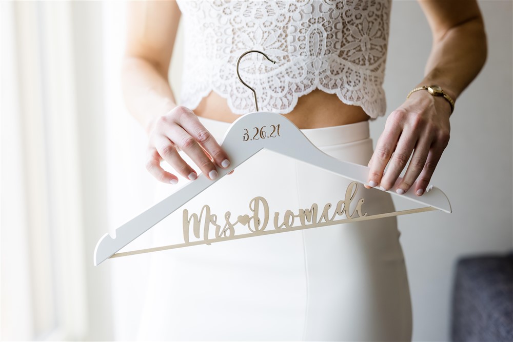 bride holding custom wedding hanger