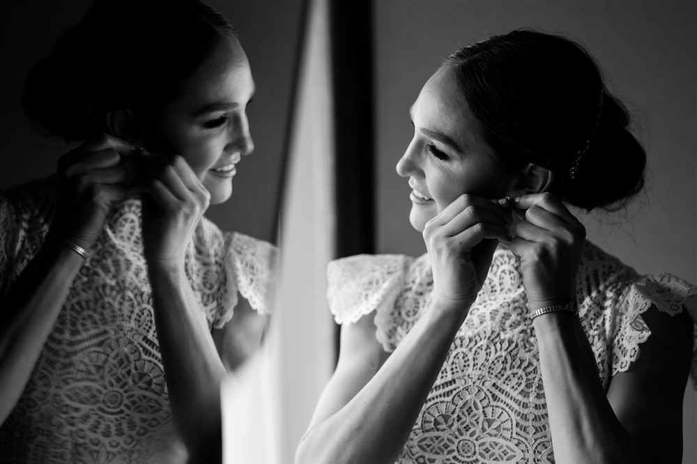 black and white image of bride getting ready