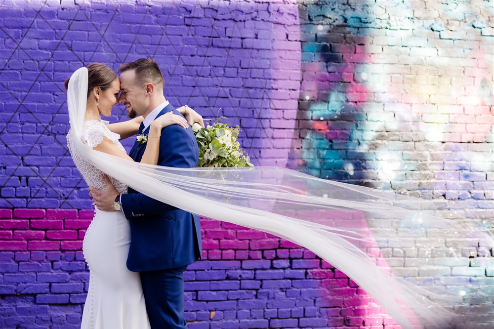 bride and groom purple wall background