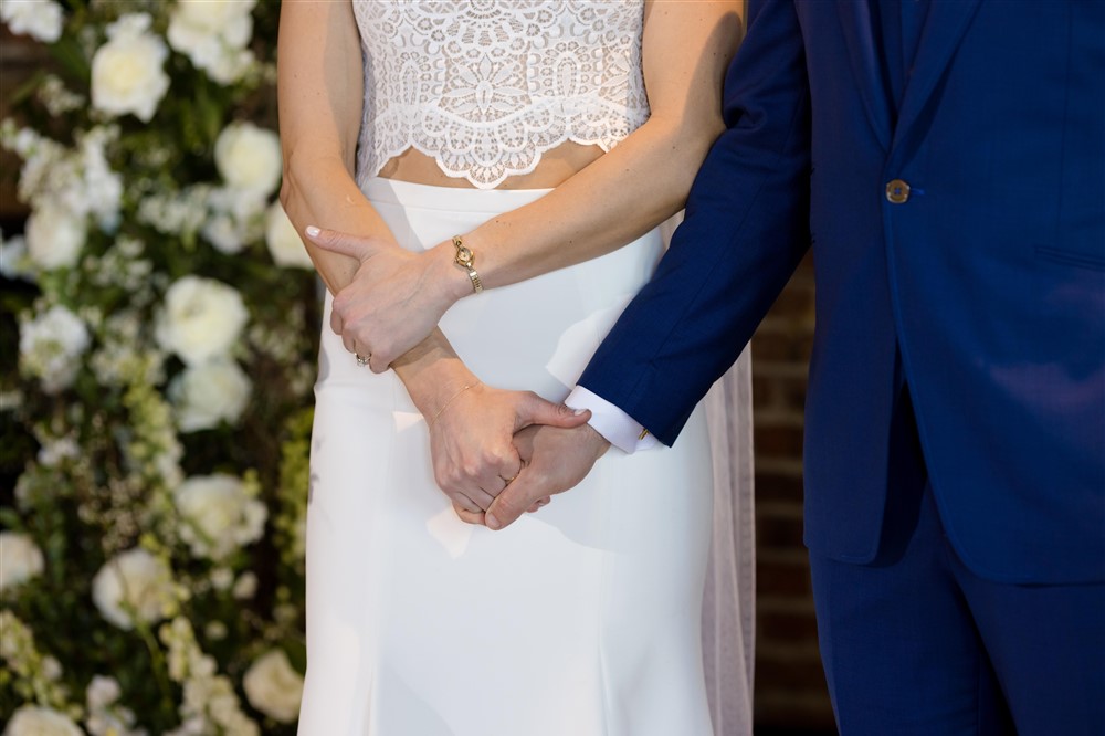 closeup of newlyweds holding hands