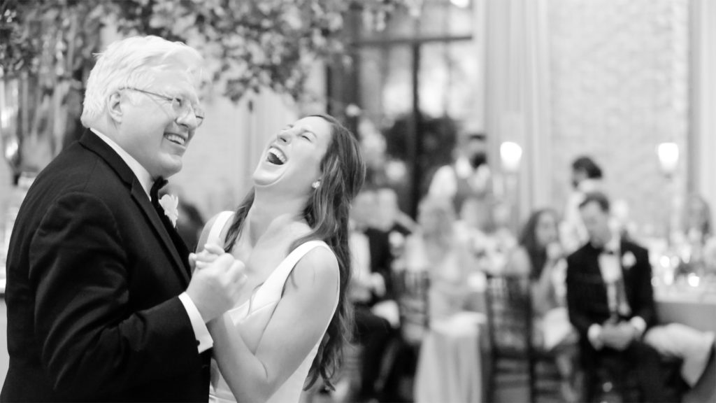 laughing bride and father dance 