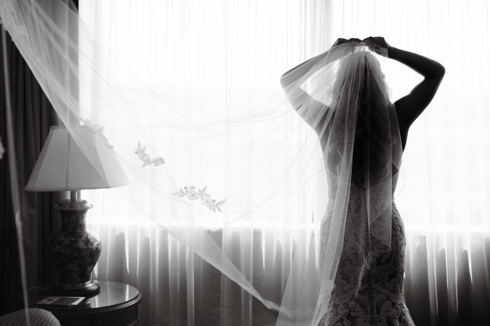 SILHOUETTE BLACK AND WHITE PHOTO BRIDE LOOKING OUT THE WINDOW